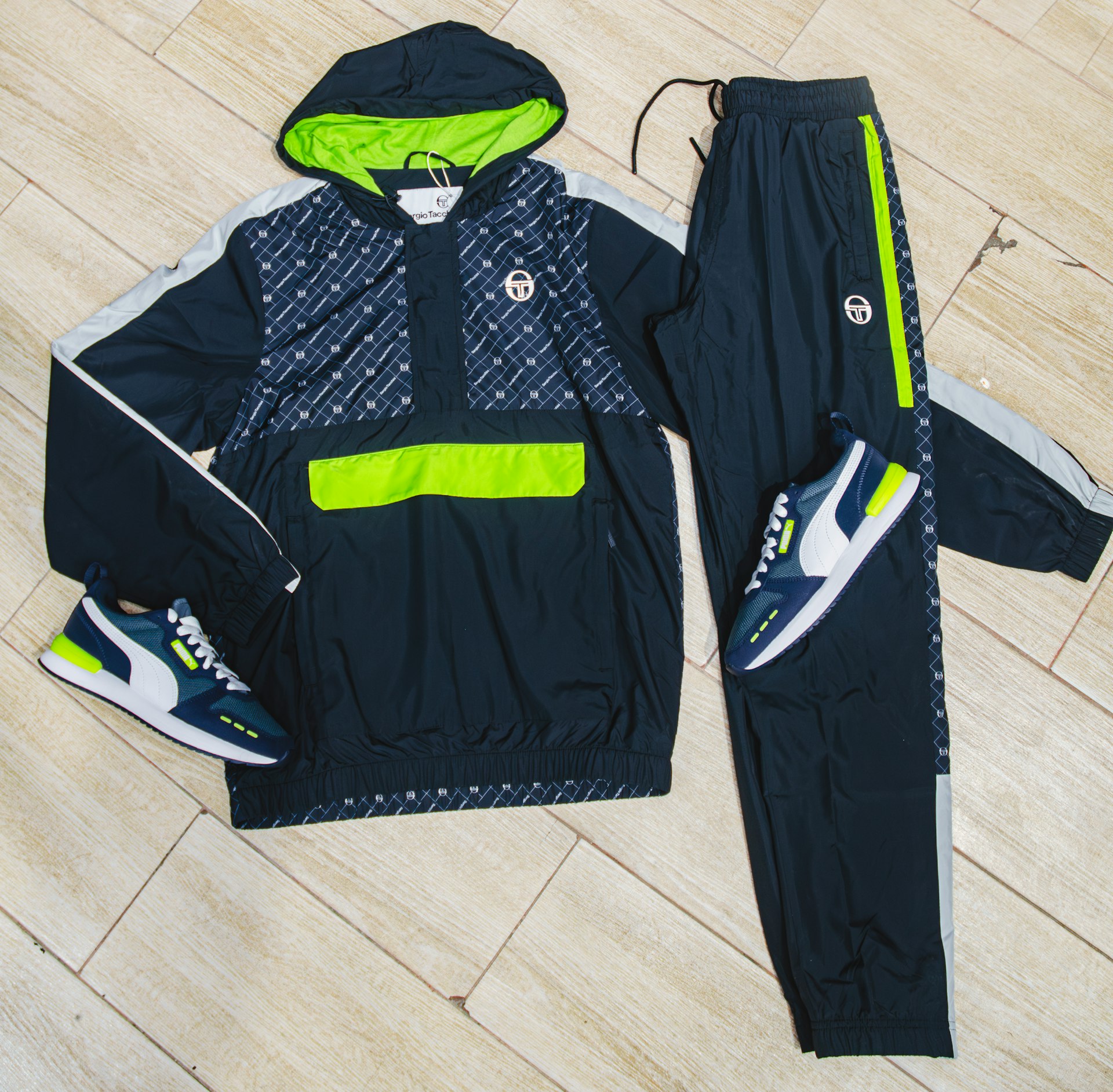 a pair of black and green tracksuits and a hoodie